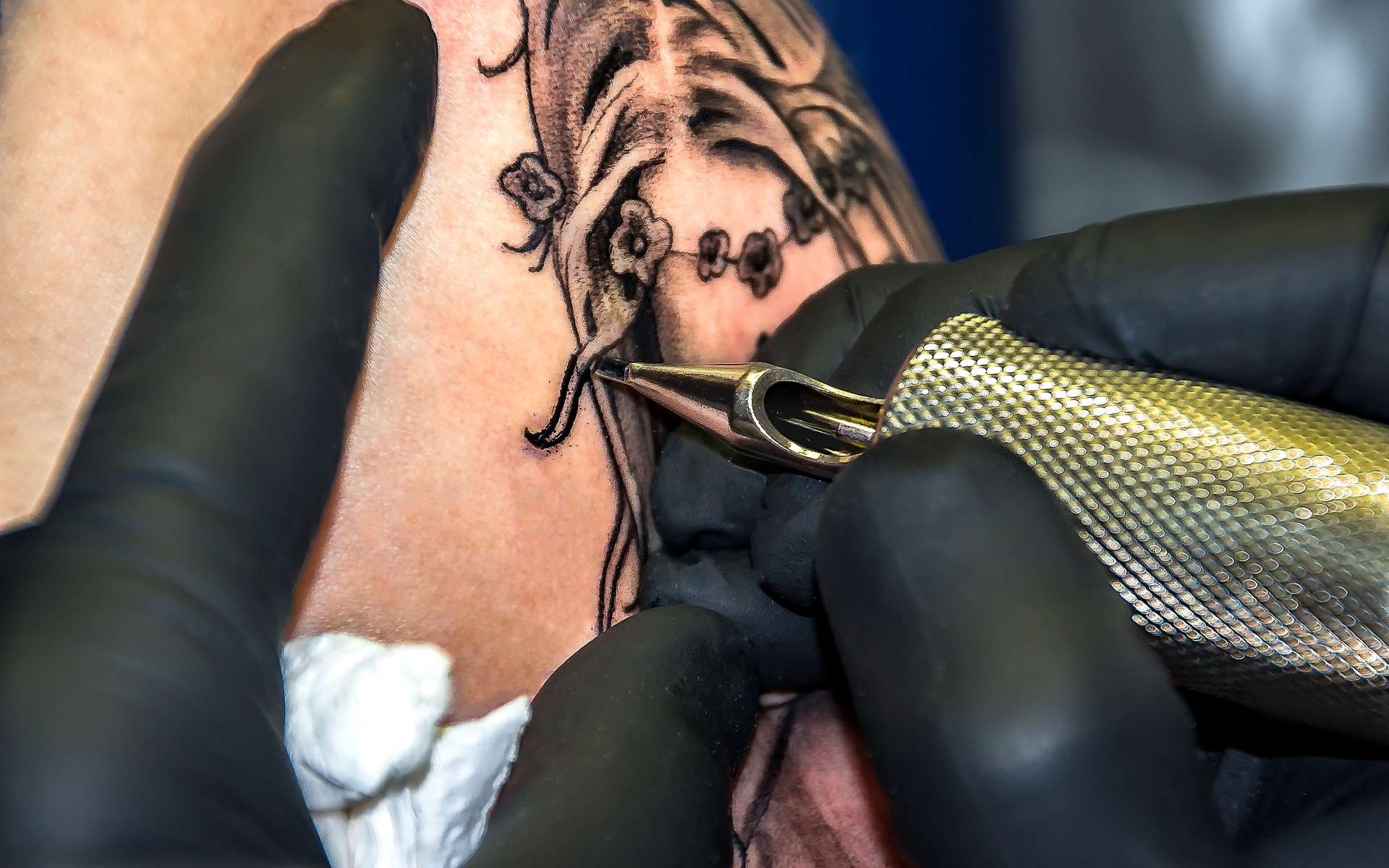 close up of a tattoo artist designing a tattoo