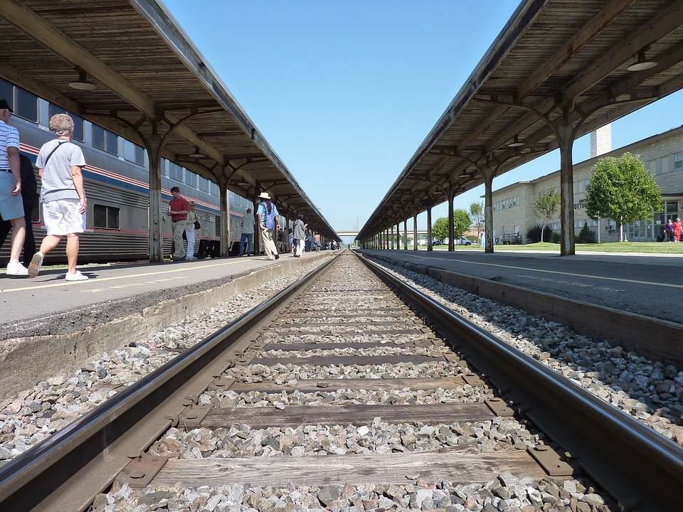 People walking along side train tracks